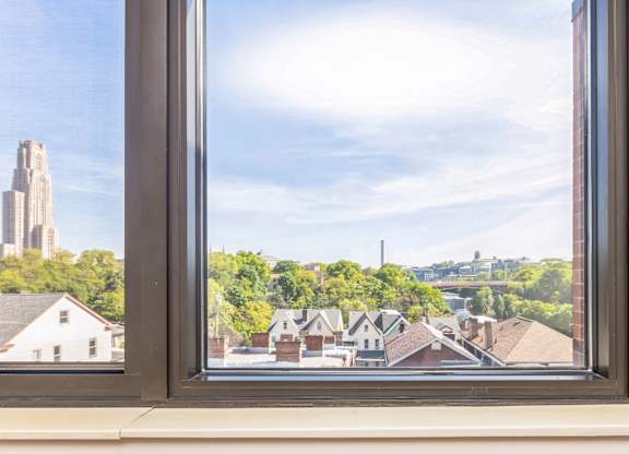 A view of a University of Pittsburgh and Carnegie Mellon University through a window.