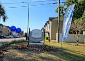 Thumbnail 1 of 28 - A Clarice Apartments sign is in front of a building.