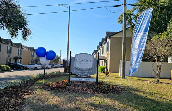 A Clarice Apartments sign is in front of a building.