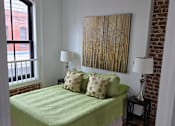 Thumbnail 11 of 22 - a bedroom with a bed and a window