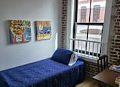 Thumbnail 13 of 22 - a living room with a couch and two books on the floor