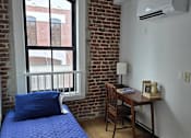 Thumbnail 15 of 22 - a bedroom with a window and a bed with a blue blanket