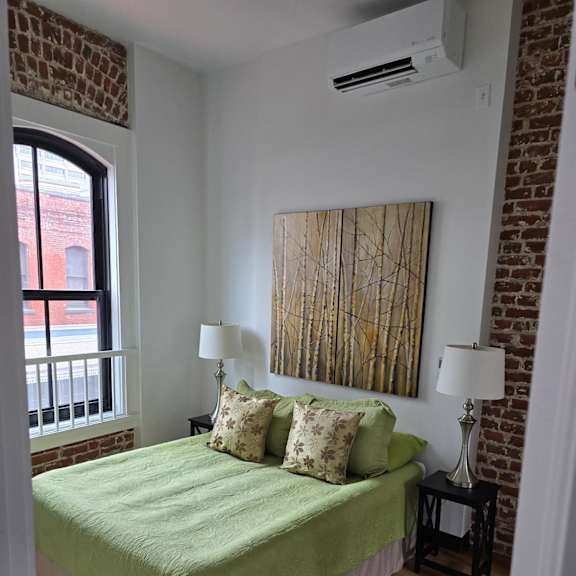 a bedroom with a bed and a window