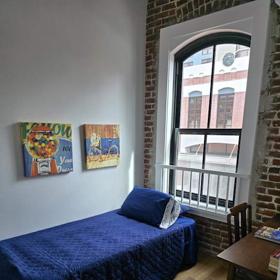 a living room with a couch and two books on the floor