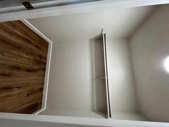 A white door is open in a room.