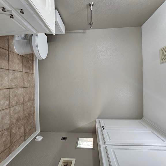 A white bathroom with a toilet and sink.