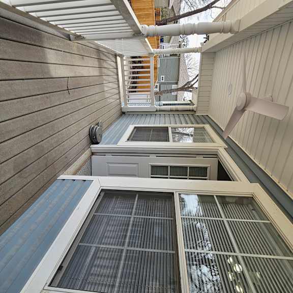 A view of a staircase leading to a balcony with a skylight above.