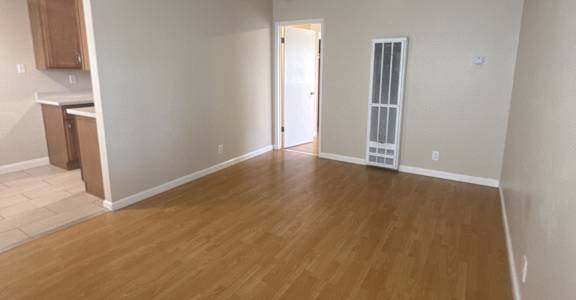 an empty room with a long desk and a wood floor