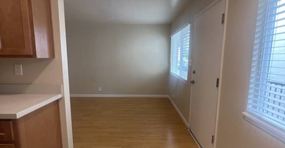a small room with two wooden cabinets and a skylight in the ceiling