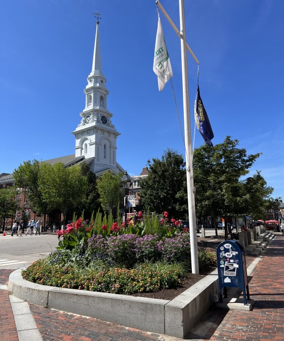 a view of three flags hanging from the side of a building