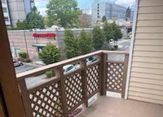 A wooden balcony with a lattice design is shown.