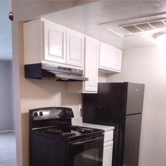 a shelf with a microwave and other appliances in a room