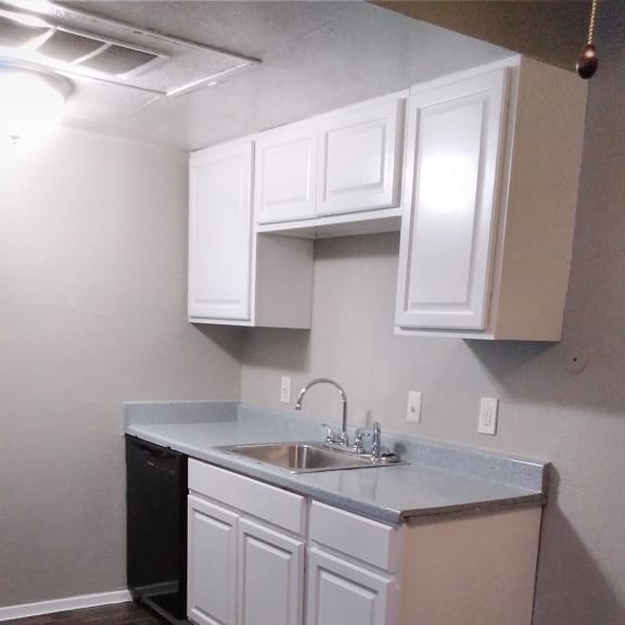 an overhead view of a kitchen with white cabinets and a wood floor