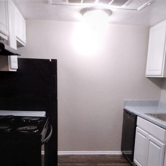 a kitchen with a refrigerator and a wood wall