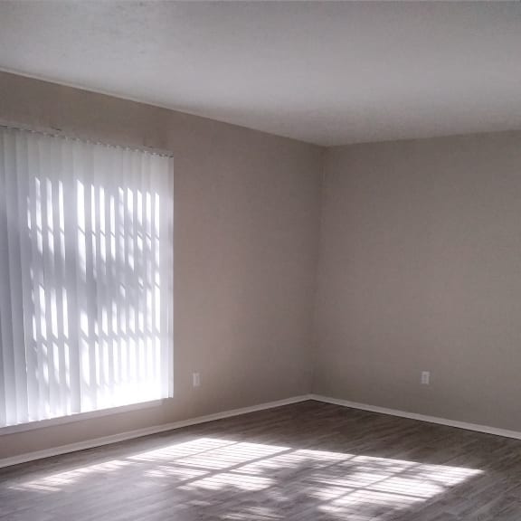 a view of a window in a hallway with a wood wall and floor