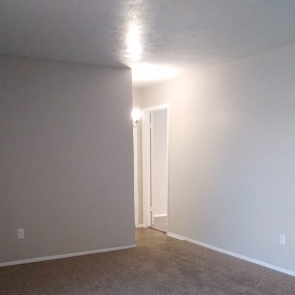 the top of a stairwell with a white wall and a light on the ceiling
