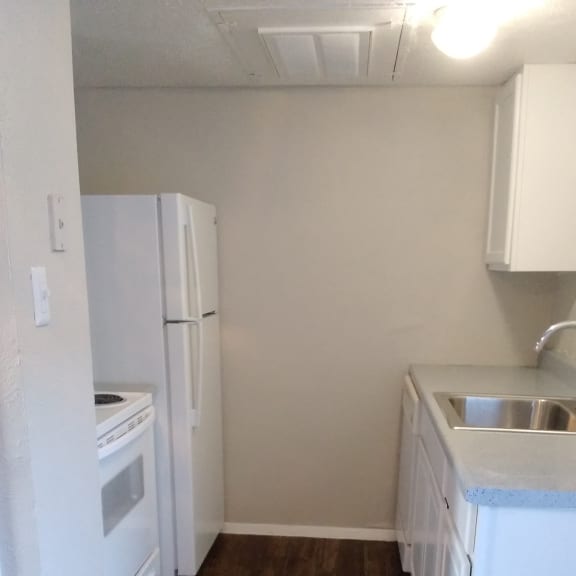 the laundry room has a washer and dryer and a wood accent wall