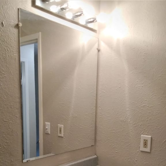 the bathroom has a urinal and a mirror in it