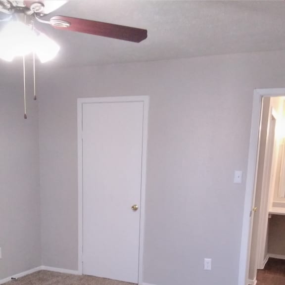 the door to the closet is in the corner of the room