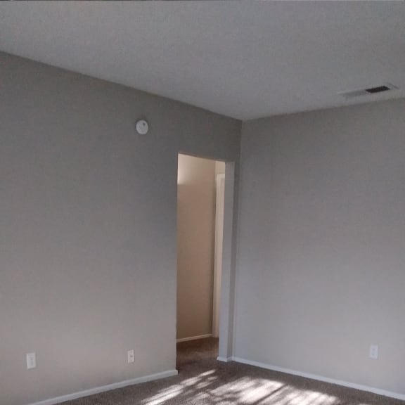 the view from the top of the stairs looking down into a room with a window