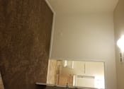 Thumbnail 8 of 41 - A small, empty room with a mirror on the wall.
