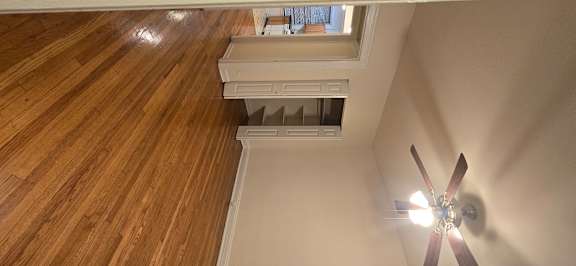 A ceiling fan is mounted on a wooden ceiling.