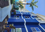 Thumbnail 21 of 21 - A blue and white striped awning over a building.