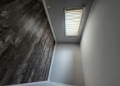 Thumbnail 14 of 17 - a window with blinds in a room with a whitewall