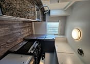 Thumbnail 12 of 17 - a kitchen with a sink and a counter top and a window