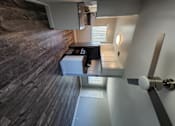 Thumbnail 9 of 17 - a view of a living room with a ceiling fan