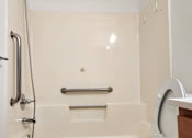 Thumbnail 17 of 18 - a white bathroom with a urinal and a sink and a mirror