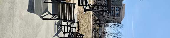 A building with a black metal railing on the side.