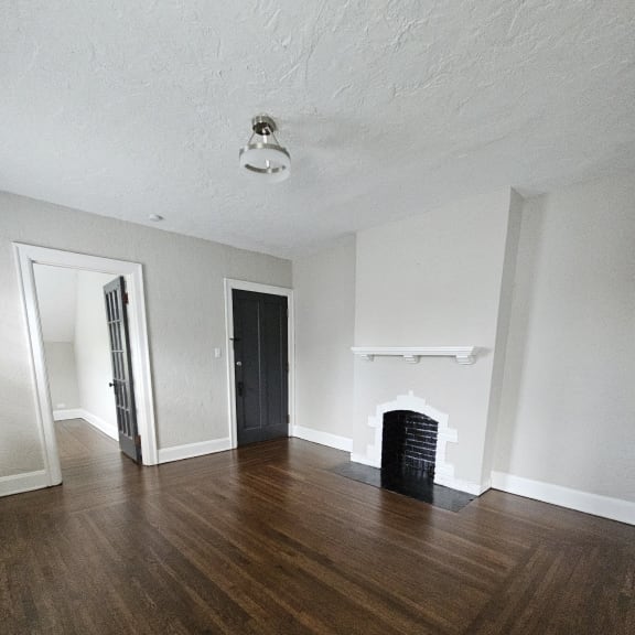 a view down a stairwell with a wood floor and white walls at Cincinnati Premier Living*, Cincinnati