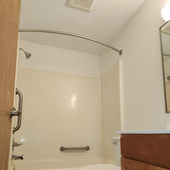 a kitchen with a sink and a faucet in the corner of a room