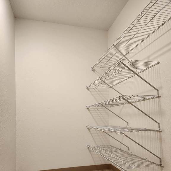 an empty room with metal bars hanging on the wall