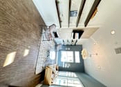 Thumbnail 31 of 44 - a large open living room with a staircase and a modern design at The Bryant Apartments at Yorba Linda, California