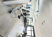 Thumbnail 36 of 44 - a row of weights machines in a gym at The Bryant Apartments at Yorba Linda, Yorba Linda California