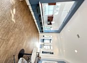 Thumbnail 37 of 44 - a living room with a glass floor and a table and chairs at The Bryant Apartments at Yorba Linda, Yorba Linda