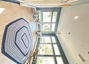 Thumbnail 34 of 44 - a sitting area in a clubhouse with rug and chairs at The Bryant Apartments at Yorba Linda, Yorba Linda, CA