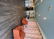 Thumbnail 16 of 17 - A kitchen with a wooden floor and a patterned ceiling.