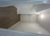 Thumbnail 5 of 17 - A white room with a wooden floor and a staircase.