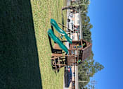 Thumbnail 10 of 17 - A playground with a slide and a wooden structure.