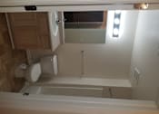 Thumbnail 16 of 41 - A white toilet is mounted on a wall in a room.