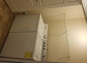 Thumbnail 7 of 41 - A white bathroom with a towel rack and a white cabinet.