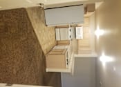 Thumbnail 9 of 41 - A modern kitchen with a white countertop and a wall-mounted oven.