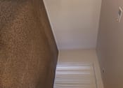 Thumbnail 11 of 41 - A white wall with a brown carpet.