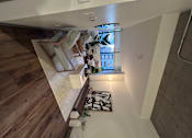 Thumbnail 4 of 38 - a living room with a chair and a window