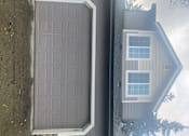 Thumbnail 79 of 82 - A grey garage door is open.