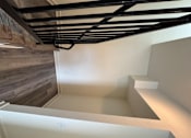 Thumbnail 3 of 24 - Corona, CA, Pet-Friendly Townhomes - Dos Lagos Townhomes - Open Living Area With Wood-Style Flooring, Neutral Walls, Recessed Lighting, and Large Windows.