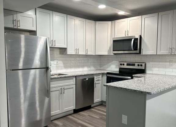 Renovated kitchen with stainless steel appliances and upgraded cabinets, flooring, and  counter tops